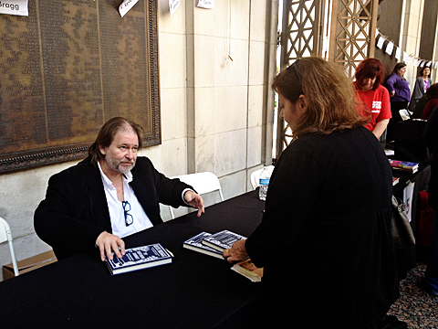 Rick Bragg signing his latest book while chatting with fans