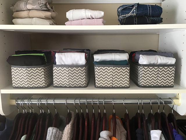 closet with bins for folded t-shirts