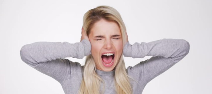 woman screaming and holding her ears