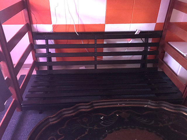 Old futon with a new purpose in the fraternity house