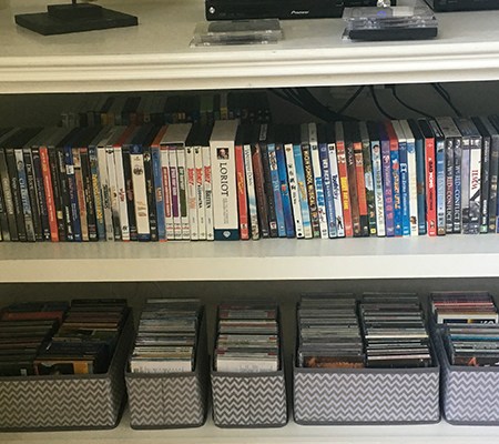 bookshelf of CDs and DVDs